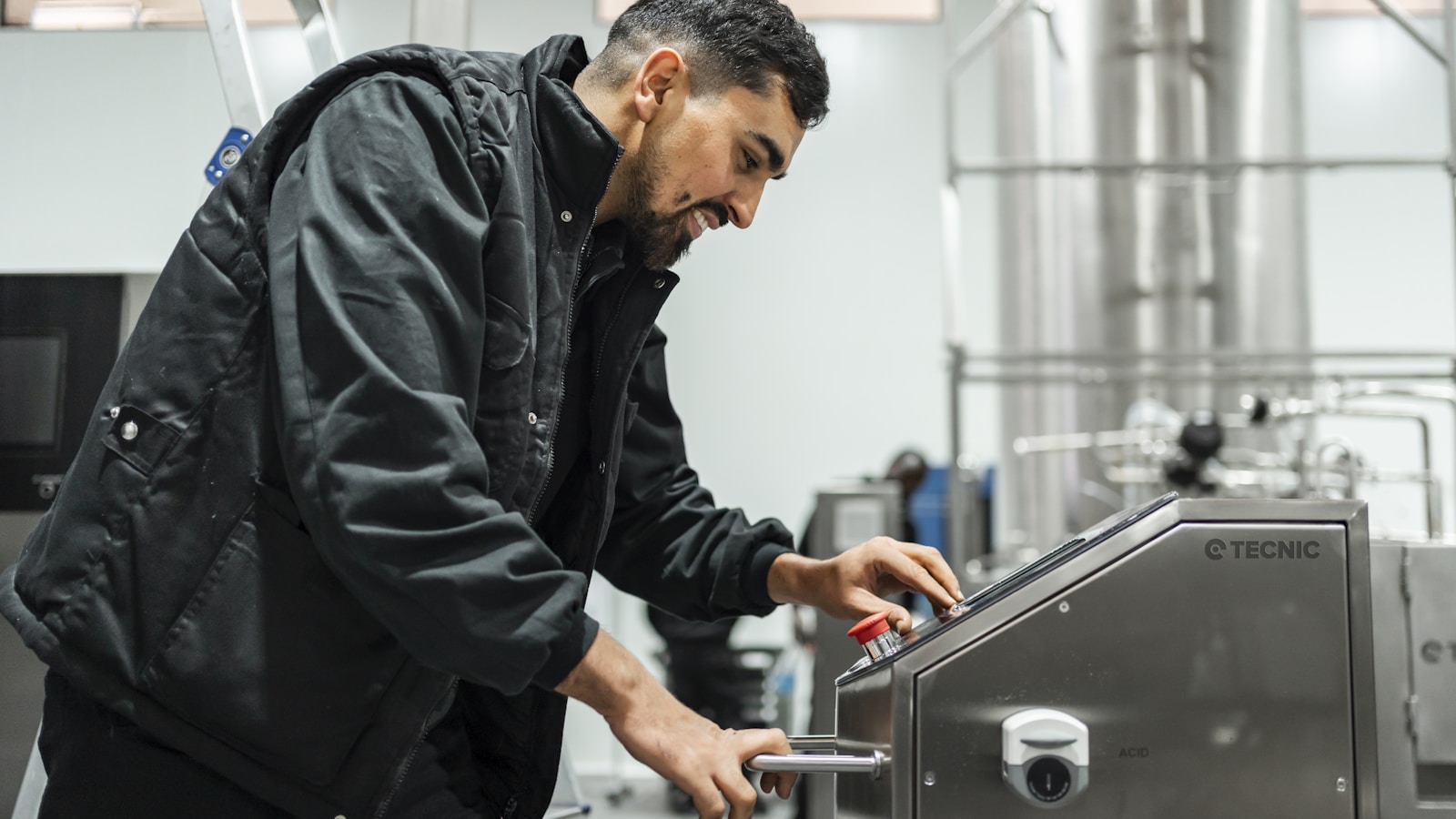 A man operates equipment in an industrial setting